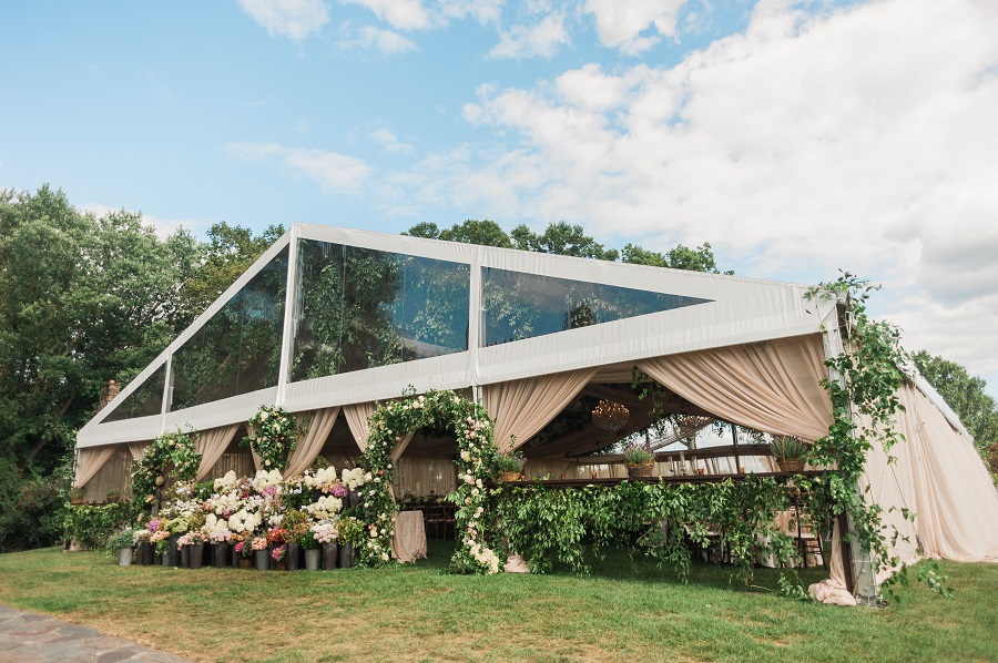 A french inspired floral display greets guests as they enter the rustic yet glamorous reception space.